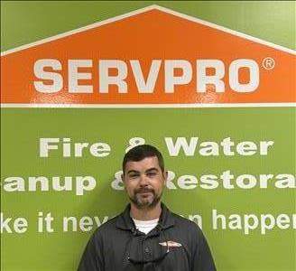 SERVPRO employee in front of green background