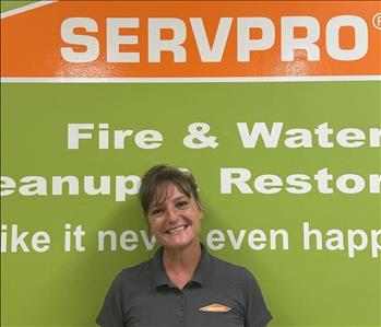 SERVPRO employee in front of green background