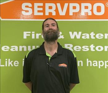 SERVPRO employee in front of green background